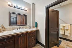Bathroom featuring vanity and baseboards