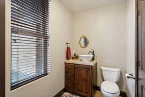 Half bathroom with healthy amount of natural light and vanity