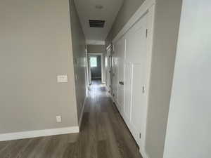 Hall featuring baseboards and dark wood finished floors