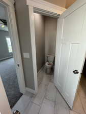 Bathroom with light marble finish flooring and ceiling fan