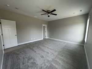 Unfurnished bedroom featuring carpet flooring, a ceiling fan, and a textured ceiling