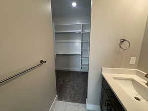 Bathroom featuring vanity and a spacious closet