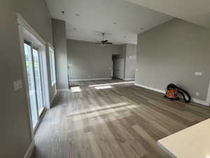 Unfurnished living room featuring light wood finished floors and a ceiling fan