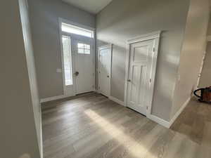 Entrance foyer featuring light wood-type flooring and baseboards