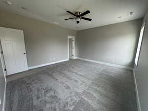 Unfurnished bedroom featuring carpet, ceiling fan, and a textured ceiling