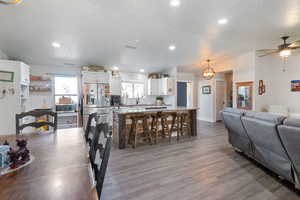 Dining room with dark wood-style floors, recessed lighting, and ceiling fan