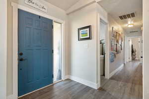 Entryway featuring dark wood-style flooring and a textured ceiling