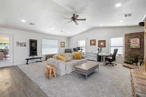 Living area featuring a textured ceiling, an office area, ceiling fan, vaulted ceiling, and recessed lighting