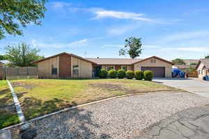View of front facade featuring driveway, stucco siding, an attached garage, and a tile roof