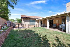 Rear view of property with stucco siding and a tile roof