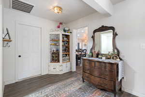 Interior space with baseboards and dark wood finished floors