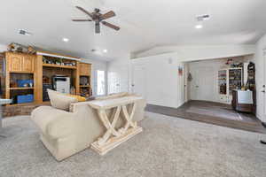 Living room with lofted ceiling, a ceiling fan, and recessed lighting
