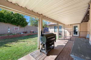 Fenced backyard with a patio and a grill