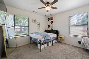Bedroom with light carpet and ceiling fan