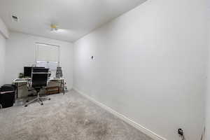 Office area featuring carpet floors and baseboards