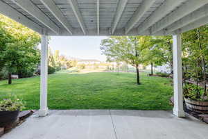 View of green lawn with a patio