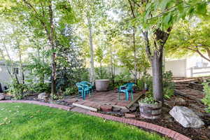 View of grassy yard featuring a deck