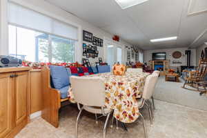 Dining area with a drop ceiling and light colored carpet
