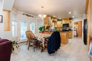 Dining room with plenty of natural light, light tile patterned floors, recessed lighting, and french doors