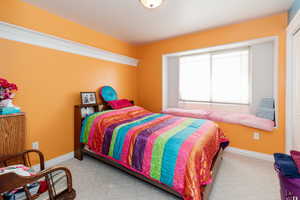 Carpeted bedroom with baseboards