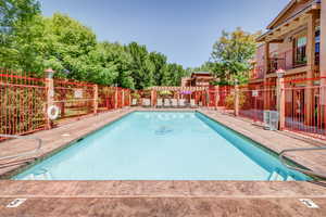 Community pool with a patio
