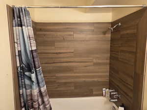 Bathroom featuring shower / bathtub combination with curtain