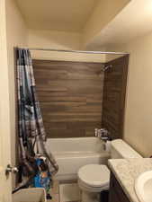Bathroom with shower / bath combo with shower curtain, vanity, and tile patterned flooring