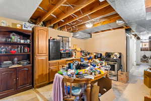 Kitchen with stainless steel appliances and concrete floors