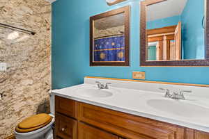 Full bath featuring double vanity and curtained shower