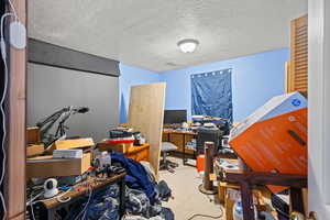 Office space featuring a textured ceiling