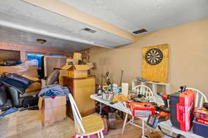 Below grade area with a textured ceiling