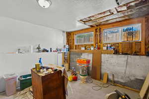 Kitchen featuring unfinished concrete flooring and a textured ceiling
