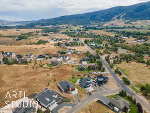 View of property location featuring mountains and nearby suburban area