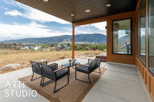 View of patio with a mountain view and an outdoor hangout area