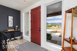 Entrance foyer featuring light wood-style floors and a mountain view