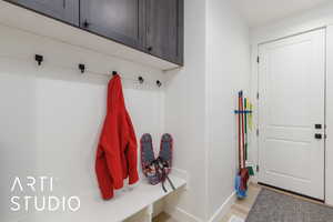 Mudroom featuring baseboards and light wood-type flooring