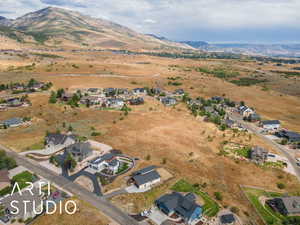 View of property location with a mountain backdrop and nearby suburban area