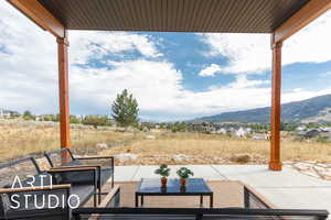 View of patio with a residential view, an outdoor hangout area, and a mountain view