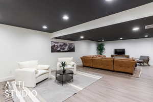 Living room featuring light wood finished floors and recessed lighting