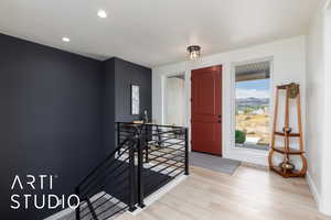 Foyer featuring light wood-style floors and recessed lighting