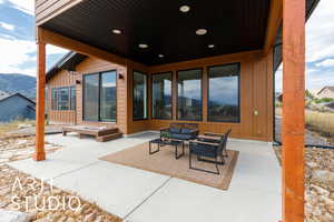 View of patio with an outdoor living space and a mountain view