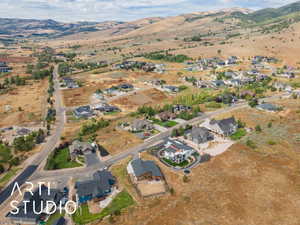 Aerial view of property's location featuring nearby suburban area and a mountainous background