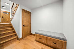 Mudroom featuring light wood finished floors and baseboards