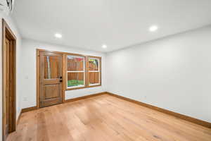 Entryway with light wood-style floors and recessed lighting