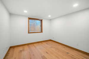Spare room featuring light wood-type flooring and recessed lighting