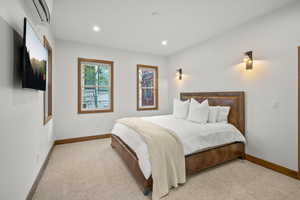 Bedroom featuring carpet, recessed lighting, and a wall mounted AC