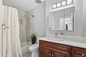 Bathroom featuring shower / bath combo and vanity