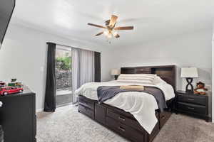Bedroom with access to outside, light colored carpet, and ceiling fan