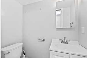 Half bath with vanity and a textured ceiling