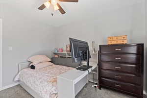 Bedroom featuring light colored carpet and a ceiling fan